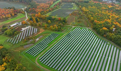Continue reading about Aerial view with fields of solar panels.