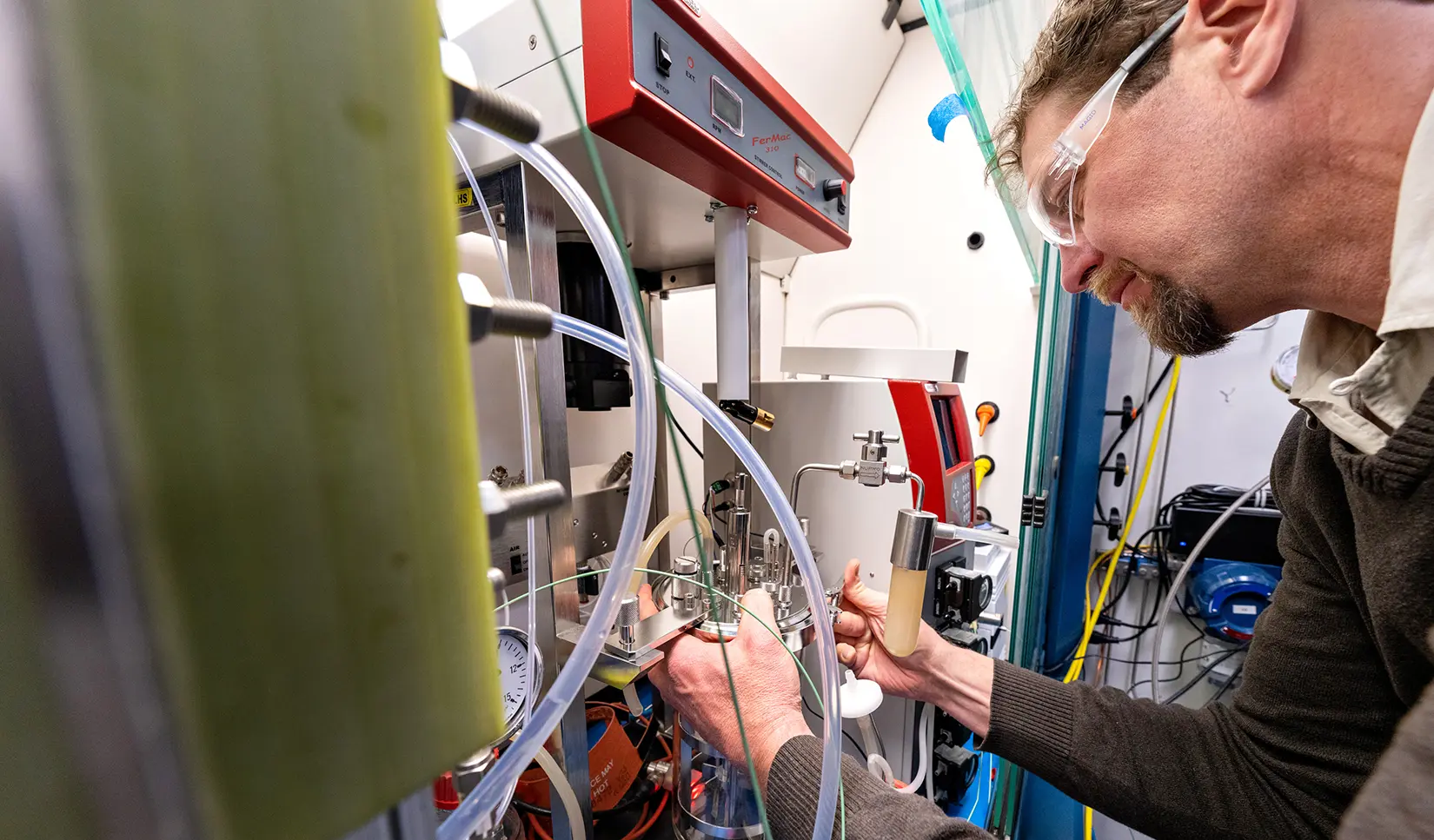 A researcher works on an electrolyzer.