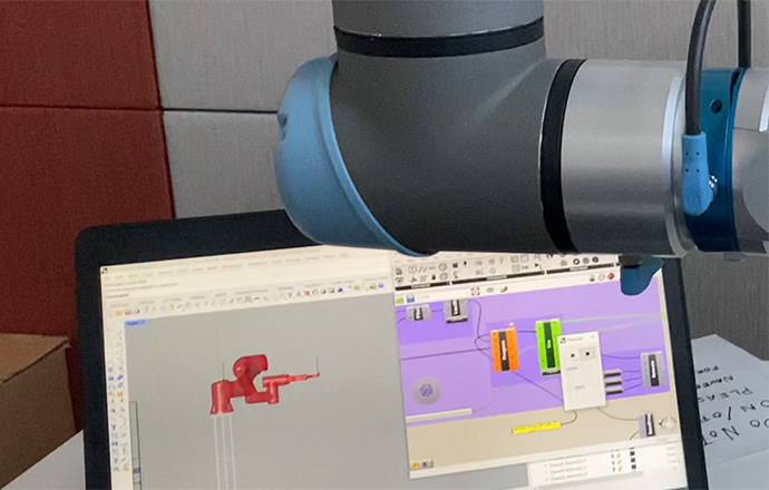 Computer screen of illustrated pipe and electrical flow with actual pipe above screen.