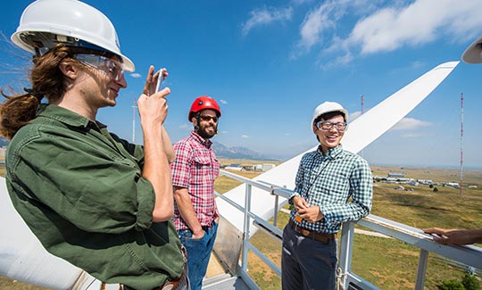 Researchers on top of wind turbine.