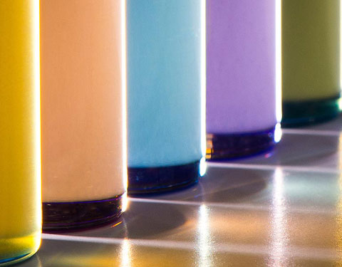 Photo of five glass tubes filled with colored fluids.