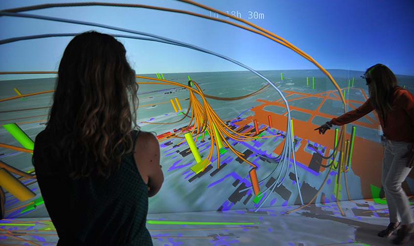 Two researchers look at a 3D model for energy resilience.