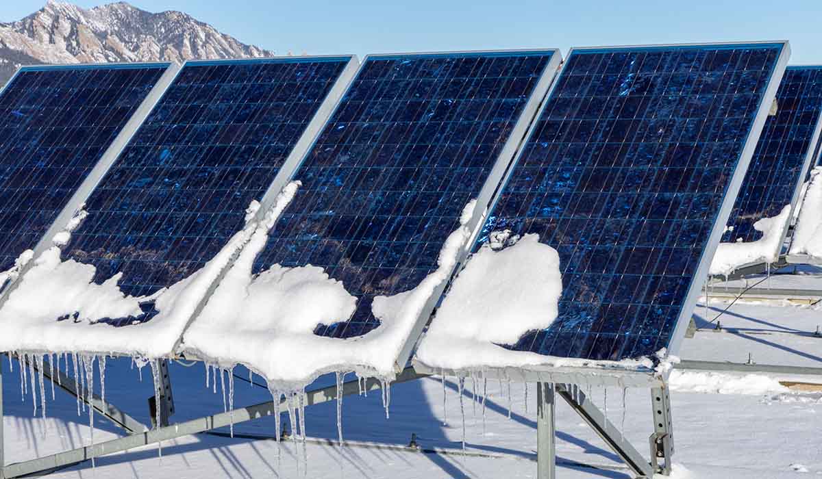 Two researchers standing next to lab equipment