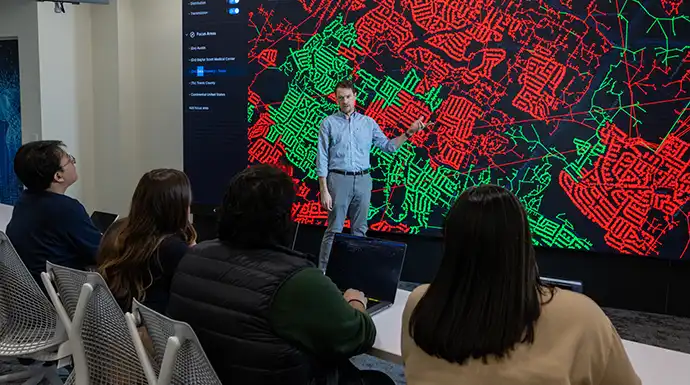 Researcher presents cybersecurity grid data to group of people