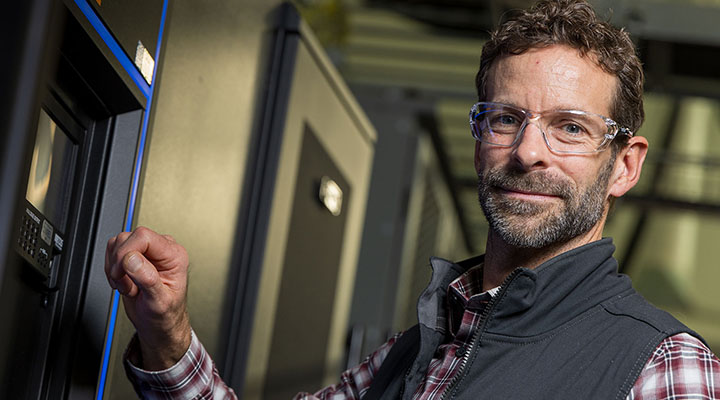 Man stands in the hallway of a research building at NREL.