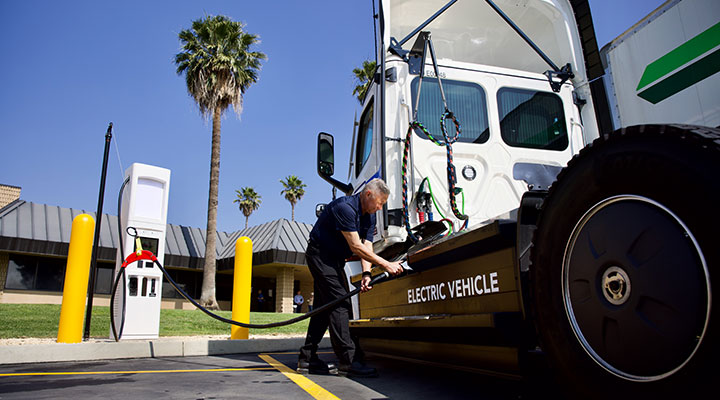 Person charging an electric semi-truck