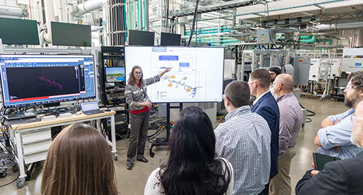 Person presenting to group of people inside lab