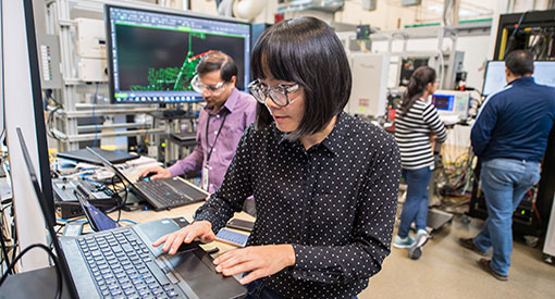 Person typing on computer inside lab