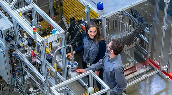 A system of interconnected pipes and two people.