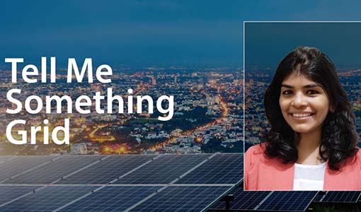 Solar panels in the forefront of city lights overlain by 