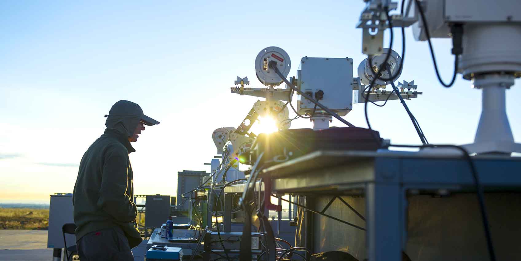 Photo of a man outdoors working with metrology equipment