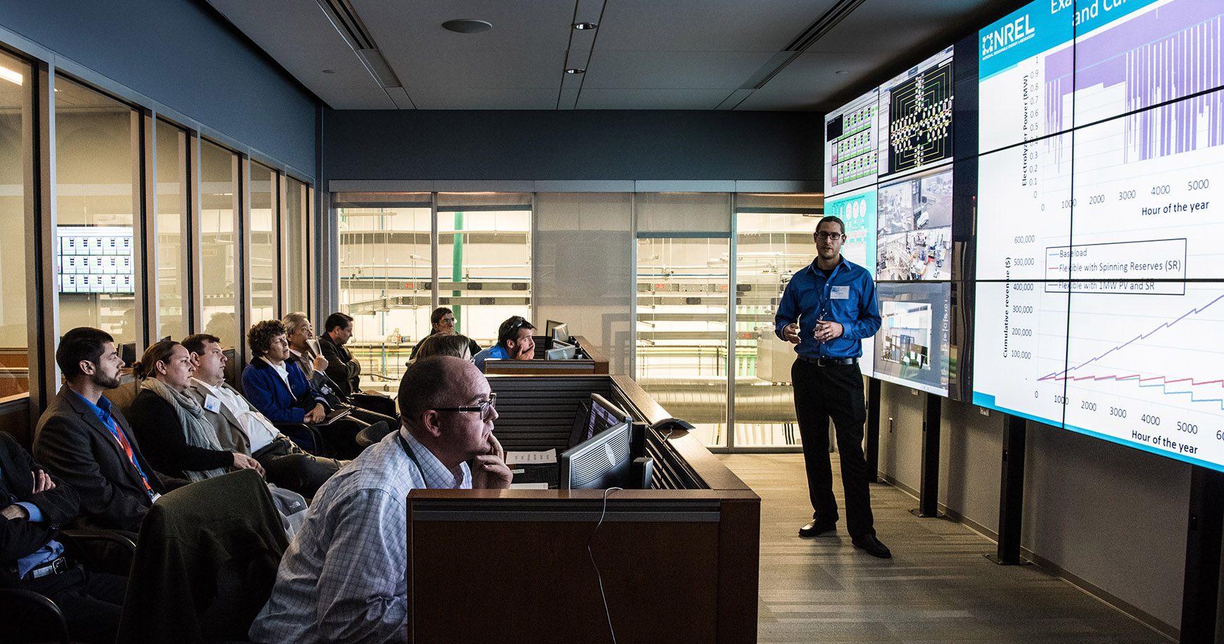 Photo of an NLR researcher presenting in the Energy Systems Integration Facility Control Room.