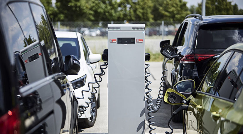 Electric vehicles parked at a charging station, charging.