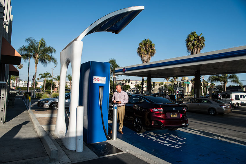 A man fuels his car at a hydrogen pump at a station in California.