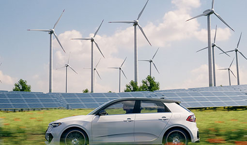 Continue reading about A vehicle driving in front of wind turbines and solar panels
