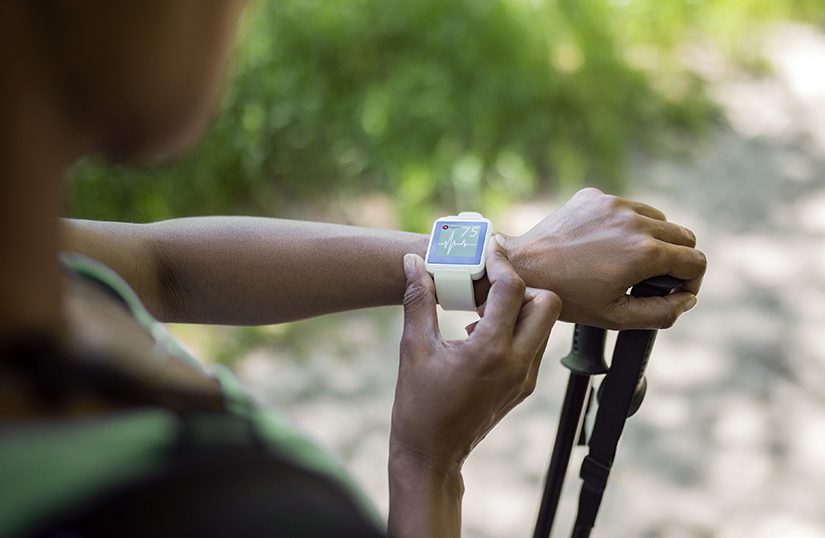 An outstretched arm wearing a smartwatch.