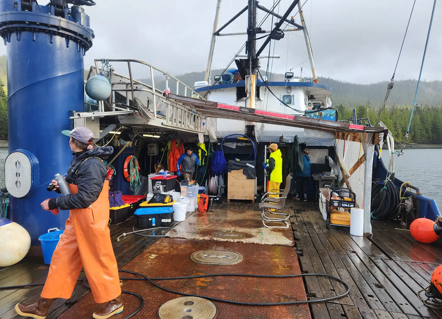 A person walks across a boat deck.