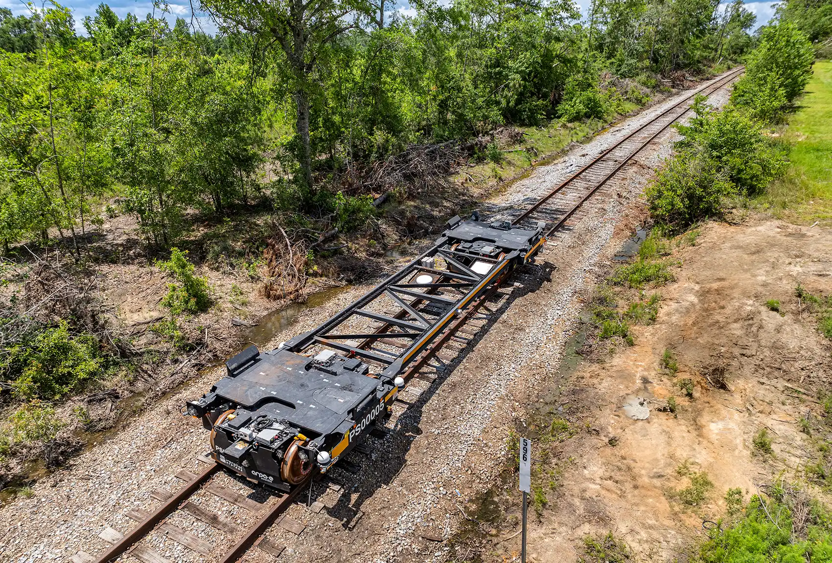 An unloaded automated rail vehicle propels itself down rail tracks in the state of Georgia.