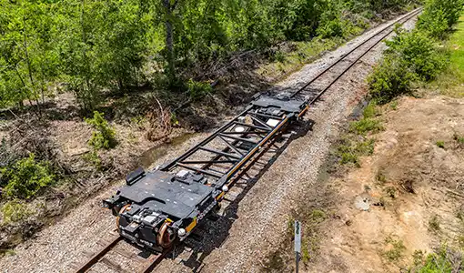 Continue reading about An unloaded automated rail vehicle propels itself down rail tracks in the state of Georgia.