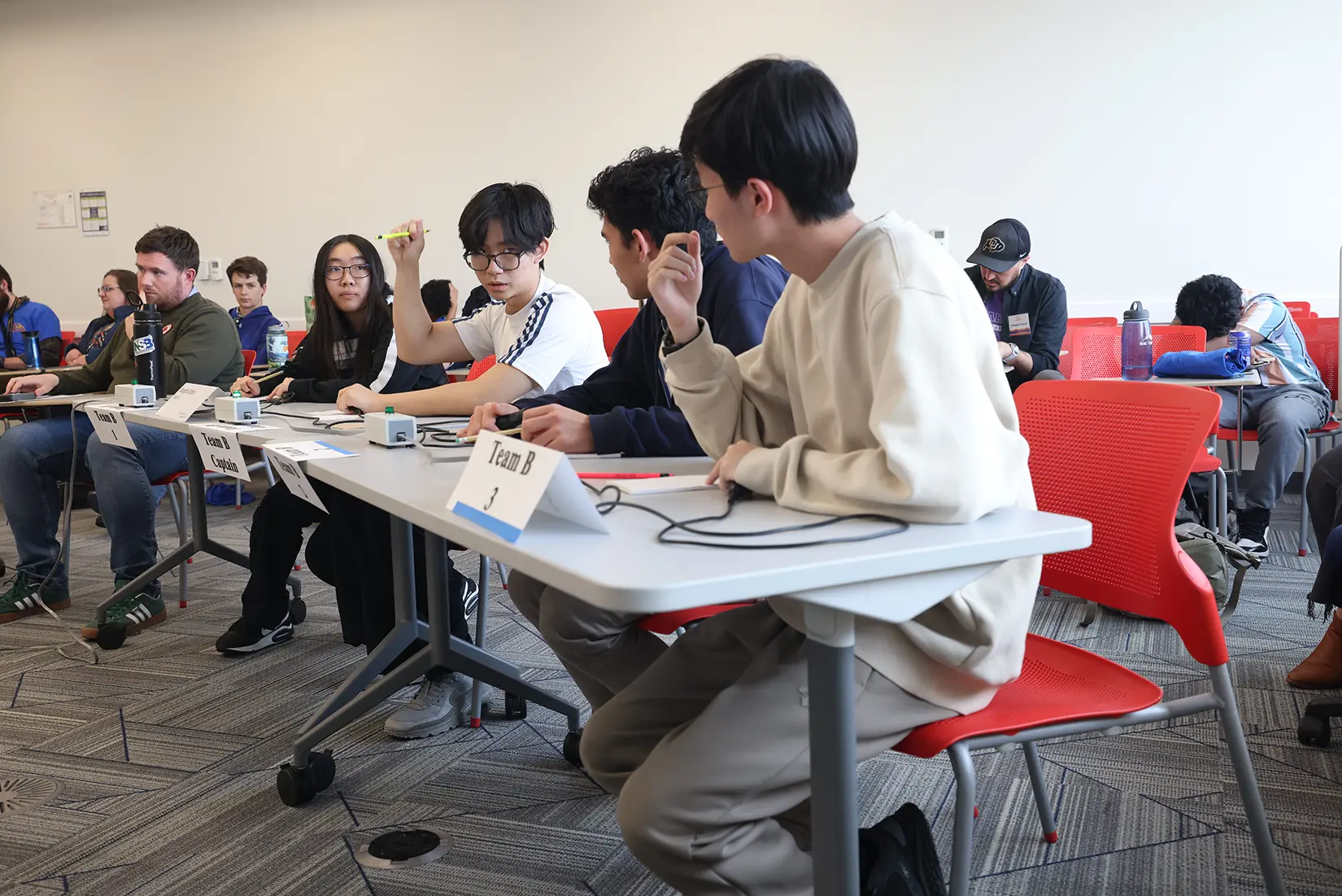 20260324-high-school-science-bowl-stargate-thornton-0A1A7933 A row of students seated at tables during a science competition