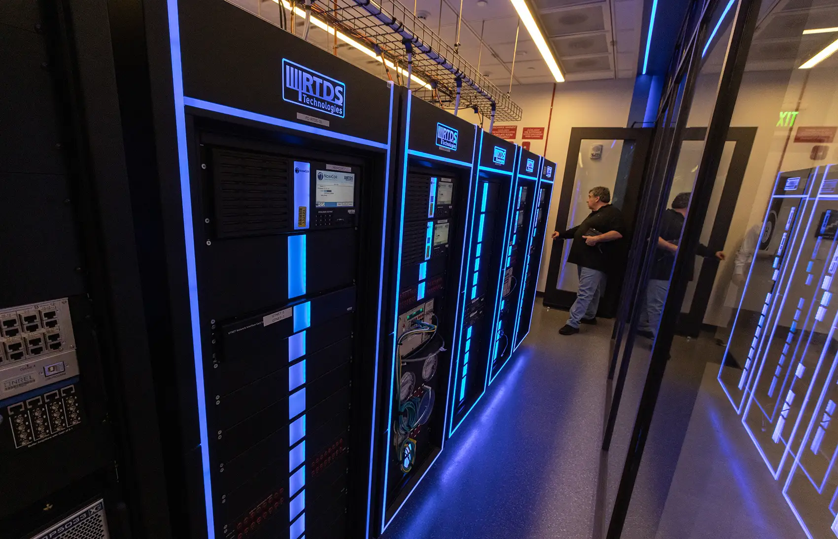 20260601-aries-in-review-5-years-of-innovation-from-a-top-energy-research-platform-103852 A person stands next to a supercomputer.