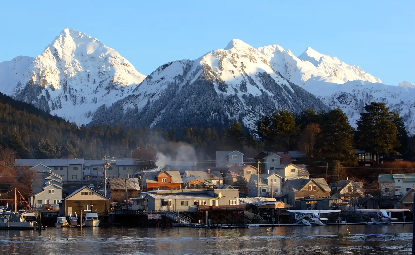 20260601-aries-in-review-5-years-of-innovation-from-a-top-energy-research-platform-getty-170616172 Snowy mountain peaks behind waterfront buildings.