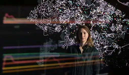 Continue reading about A person in the reflection of a screen with a map on it.