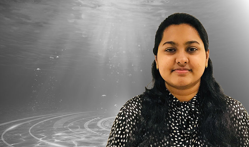 Ritu overlain on a black-and-white photo of underwater.