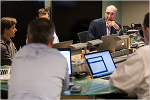 NREL researcher looks across table at meeting