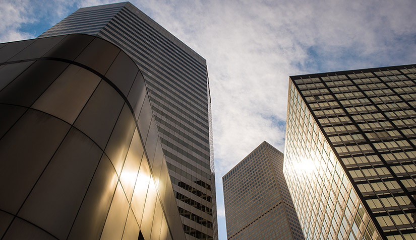  The skyline of downtown Denver features many buildings with glass facades.