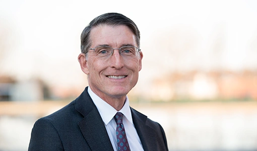 Continue reading about Portrait photo of a man in a suit and tie