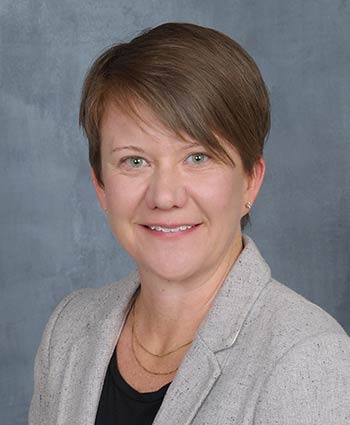 Headshot of a woman in professional ware.