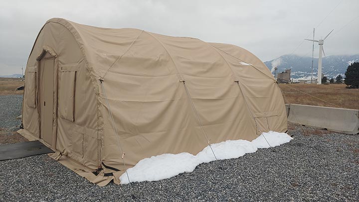 A Quonset hut situated next to electric research infrastructure