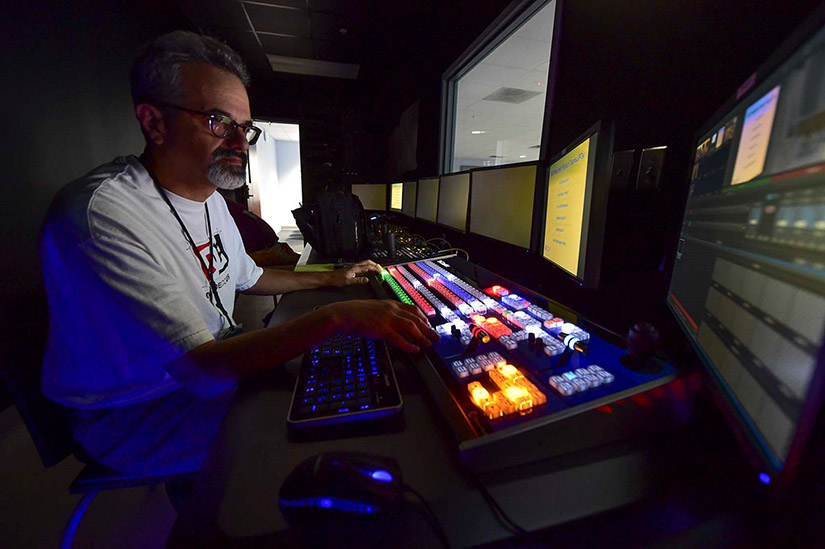 Photo of a man working at a computer station
