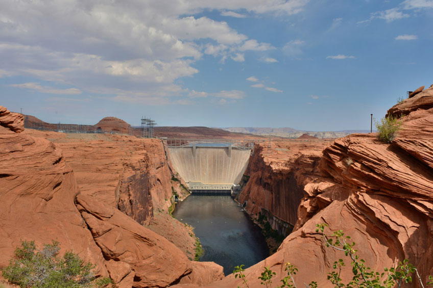 Photo of a dam with a reservoir in the foreground.