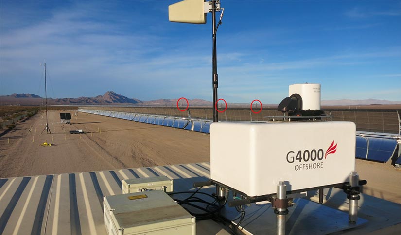 Pieces of square equipment in foreground with blue skies in background.