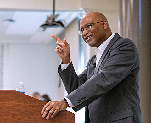 A man speaks at a podium