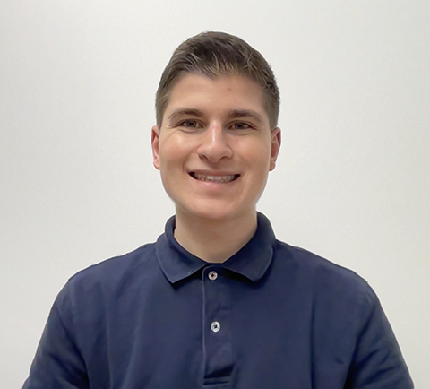 A headshot of a smiling Nicholas May-Varas.