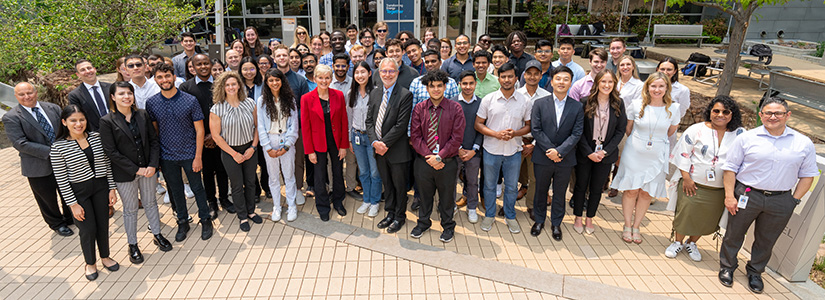 A large group of interns stand with Lab Director Martin Keller and Secretary Granholm.