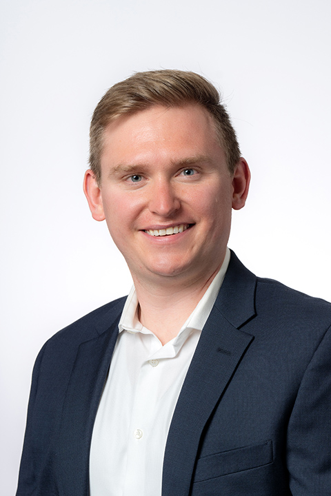 A man smiles at a camera