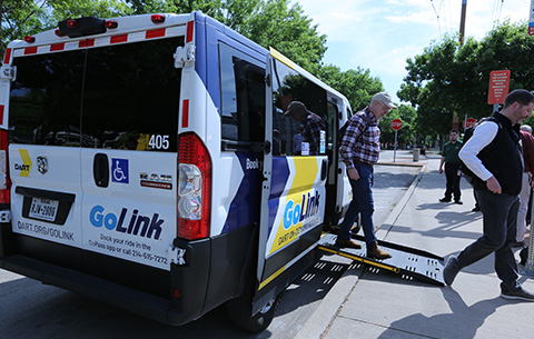 A man steps off of a GoLink on-demand shuttle.