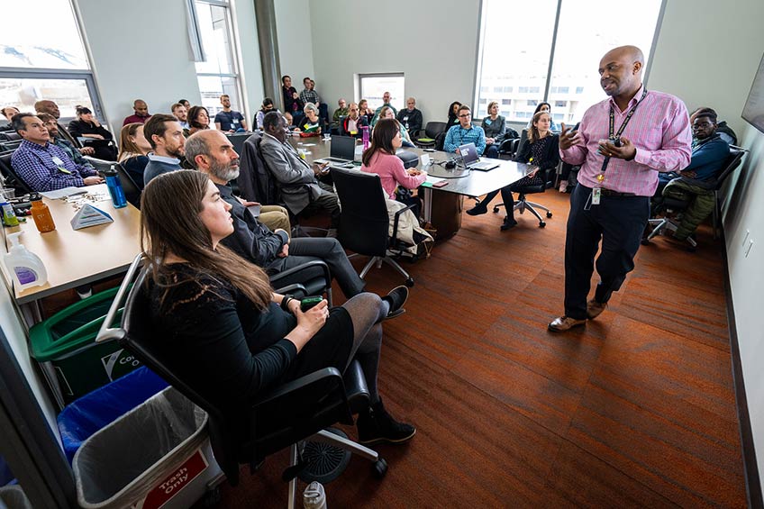 A man speaking to a large group of people.