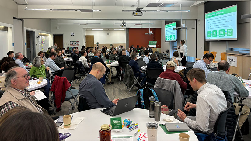 Group of people sit in conference room listening to presentation