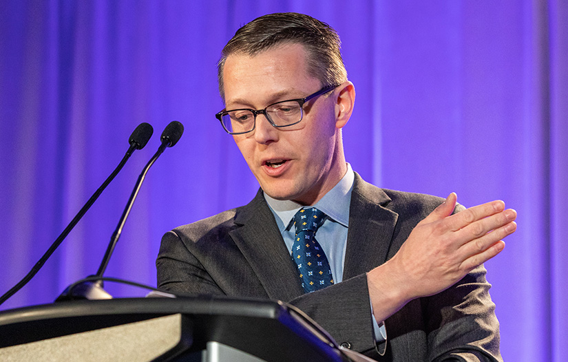 A man speaks at a podium. 