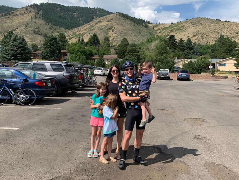 A family in a parking lot. 