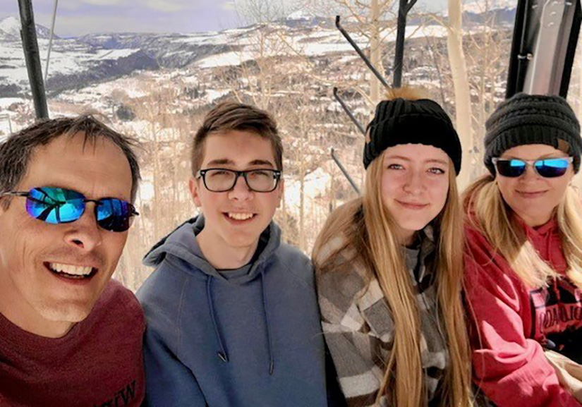 Four people smiling. 