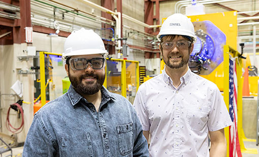 Two researchers in hardhats in a lab