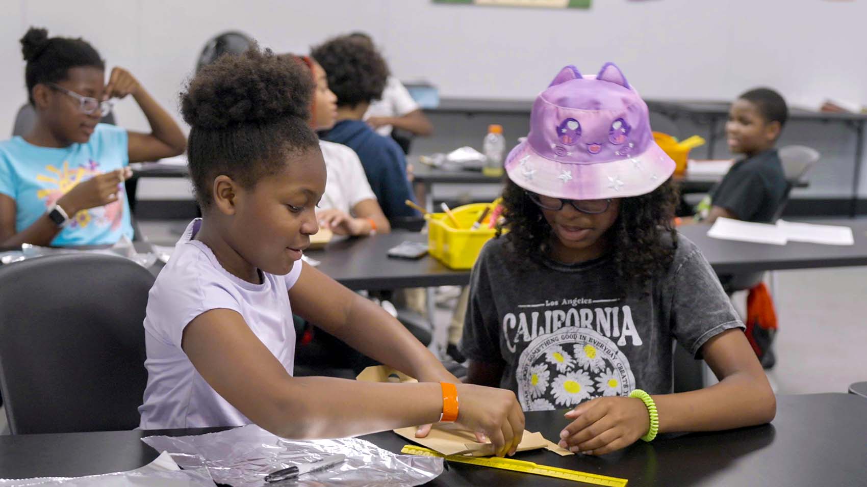Students work together at a table in a classroom