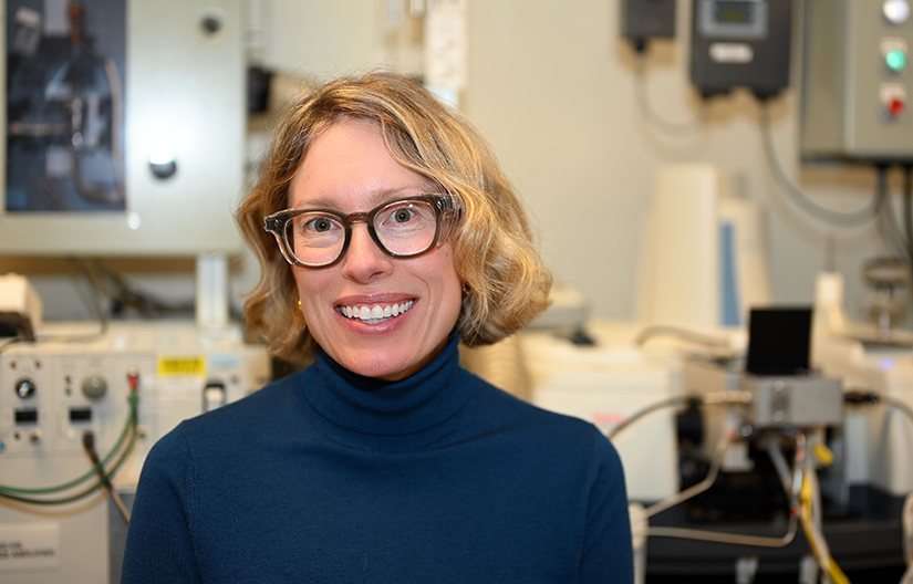 A woman smiling in a lab. 