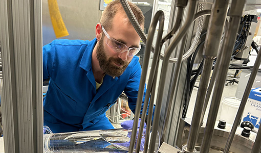 Continue reading about A researcher pours a liquid into a machine in a lab.